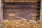 Woodpile and wooden wall of old barn of brown color