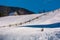 Woodshed above the snowy hillside with fence