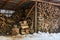 Woodshed full of chopped firewood in winter