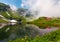 Woodshed on the grassy shore of Balea lake