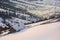 Woodshed on hillside in deep snow