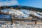 Woodshed on the hillside in winter mountains