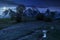 woodshed among trees on a hill by the road in High Tatras at night