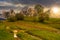 Woodshed among trees on a hill by the road in High Tatras at sun