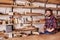 Woodwork craftsman in studio with shelves of wood pieces