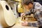 Woodworker Building Guitar in Workshop