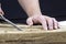 Woodworker carves wood pieces. Hands doing wood carving.Handicrafts.A woodcarver processes a wood board with a chisel