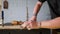 A woodworker cuts cuts in an oak board with a tongue-and-groove. carpenter works with combination plane. the sounds of hand