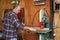 A woodworker cutting a board