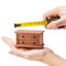 Woodworker measuring chest of drawers with a tape measure