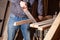 Woodworker sawing a board with a hand saw,carpenter workflow