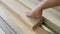 Woodworker saws plank on a table circular saw.