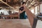 Woodworker skillfully inspecting a wooden plank in his workshop