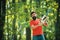 Woodworkers lumberjack. Stylish young man posing like lumberjack. Lumberjack worker standing in the forest with chainsaw