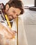 Woodworking passion. A handsome young carpenter measuring and marking wood.