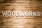 WOODWORKS word made of wooden block letters on wooden board