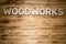 WOODWORKS word made of wooden letters on wooden board