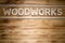 WOODWORKS word made of wooden letters on wooden board