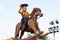 Woody from Toy Story on a rocking horse on float in Disneyland Parade