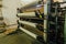 Wool thread production line. Spinning machinery with spindles and wool yarns