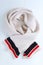 Woolen beige scarf a with colored stripes around the edge. Winter clothes