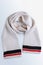 Woolen beige scarf with colored stripes around the edge. Winter clothes