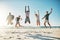 Woop Woop Summer break is here. a group of young friends jumping enthusiastically in the air at the beach.