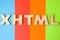 Word or abbreviation XHTML, meaning Extensible HyperText Markup Language as internet programming language is on background of four