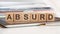 the word absurd is written on wooden cubes, concept