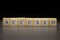 The word ACCUSED written on wooden cubes, isolated on a black background