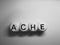 Word ache spelled on wooden dice