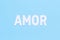 Word AMOR on a light blue background