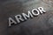 The word armor laid with silver metal letters on rusted iron flat surface background