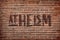 Word Atheism on brick wall. Philosophical or religious position