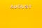 Word August on yellow background