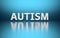 Word Autism on blue background
