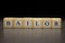 The word BAILOR written on wooden cubes isolated on a black background