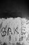 Word bake written in flour on table