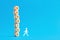 The word barrier on tiered wooden cubes with a walking stick man on blue background. To overcome stress, pressure or difficulties