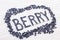 Word berry written letters with blueberries on white wooden boar