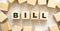 The word BILL consists of wooden cubes with letters, top view on a light background