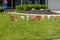 The word BIRTHDAY written in individual colorfully decorated letter signs was seen on a lawn