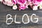 Word Blog with Pink Roses on a Rustic Wooden Background