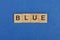 Word blue made from brown wooden letters