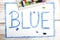 Word BLUE written in blue crayon