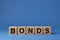 Word Bonds made of wooden cubes with letters on blue background