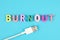 Word burnout from multi colored wooden letters and usb plug on blue background