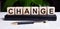 The word CHANGE is written on the wooden cubes of the diary near the handle