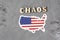 The word Chaos sign on gray background with american flag