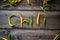 Word CHILI made of raw organic yellow and green chili cayenne peppers